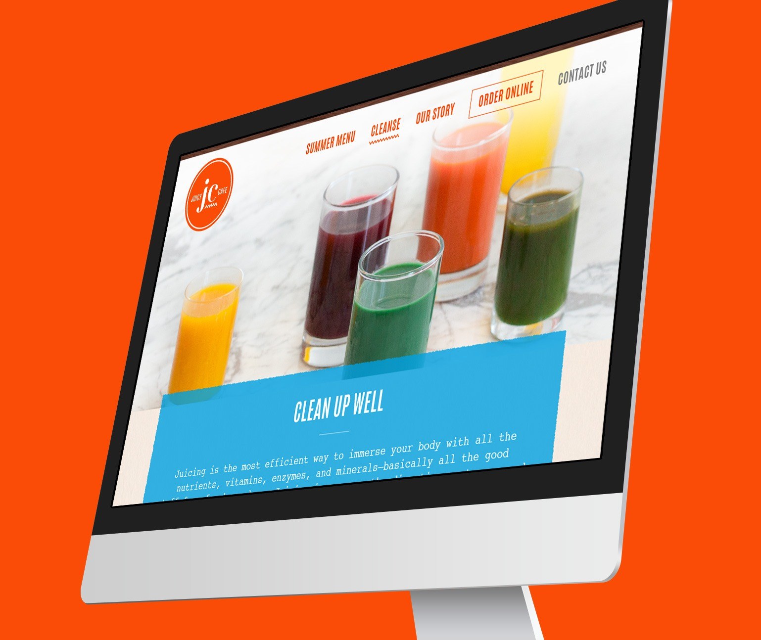 Juicy Cafe website design shown on computer monitor with an orange background